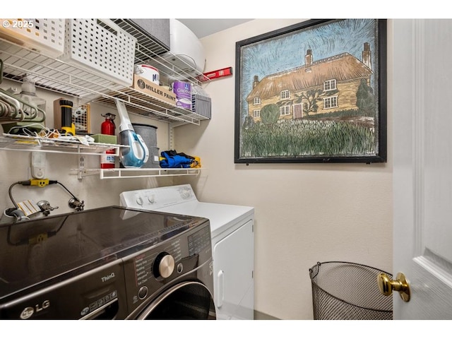 clothes washing area featuring laundry area and washing machine and clothes dryer