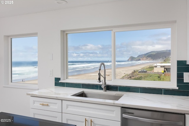 3929 NW Jetty Ave Unit 5, Lincoln City, OR 97367 - kitchen featuring dishwasher, a sink, plenty of natural light, and light stone counters