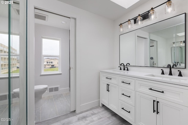 3929 NW Jetty Ave Unit 5, Lincoln City, OR 97367 - bathroom with toilet, baseboards, and double vanity