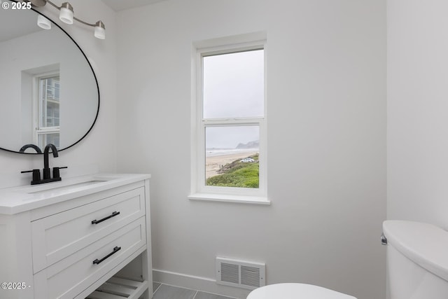 3929 NW Jetty Ave Unit 5, Lincoln City, OR 97367 - bathroom with toilet, baseboards, and vanity
