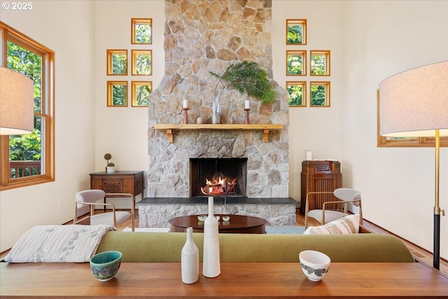 4908 SW Barnes Rd, Portland, OR 97221 - living area with a fireplace, plenty of natural light, a high ceiling, and baseboards