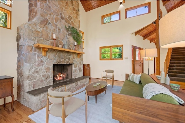 4908 SW Barnes Rd, Portland, OR 97221 - living room with high vaulted ceiling, wooden ceiling, a fireplace, healthy amount of natural light, and wood finished floors