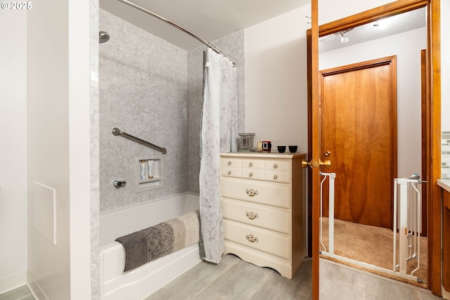 bathroom featuring shower / bath combo and hardwood / wood-style flooring