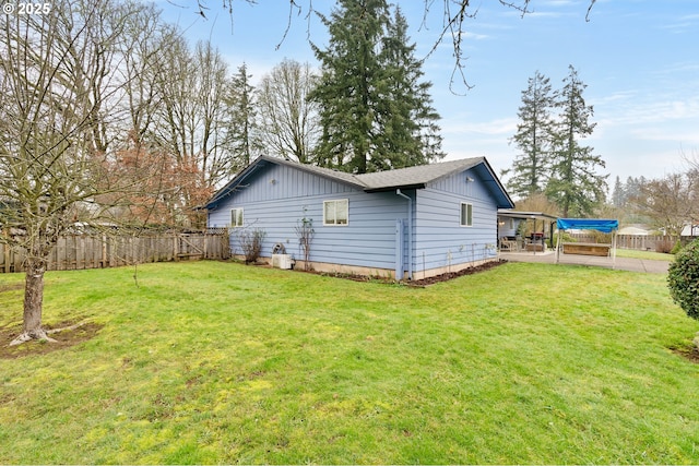 back of property with a yard and a patio