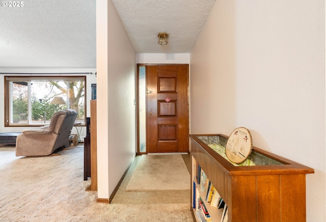 corridor featuring a textured ceiling and light carpet