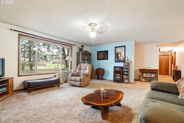 carpeted living room with a textured ceiling and ceiling fan