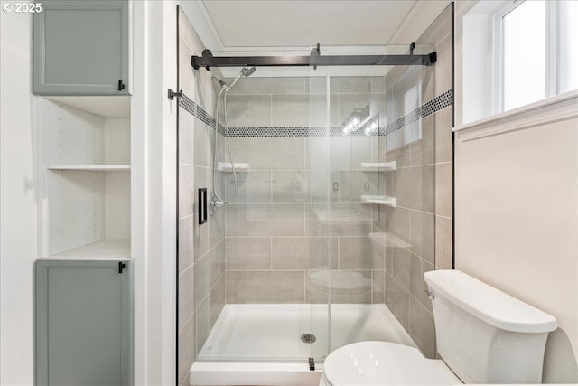 full bath featuring a stall shower and toilet