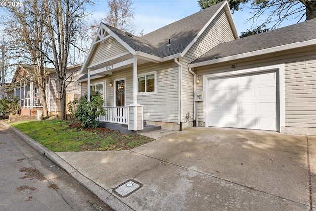 view of front facade featuring a garage, concrete driveway, and a shingled roof