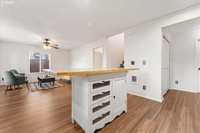 kitchen with visible vents, butcher block counters, light wood-type flooring, and white cabinetry