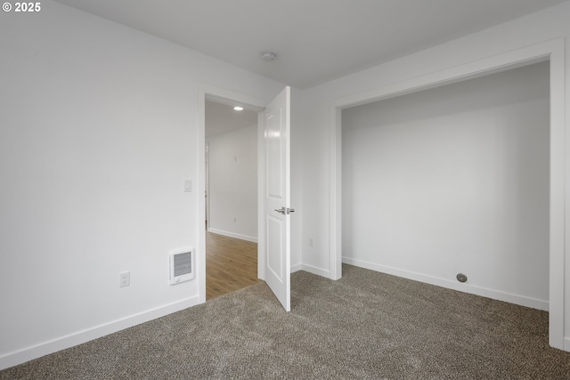 interior space with carpet, visible vents, and baseboards