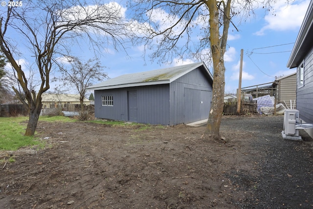 view of outdoor structure featuring an outbuilding and fence