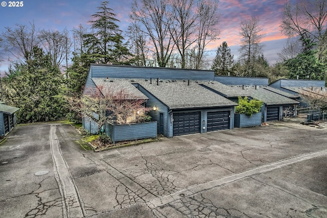 view of garage at dusk