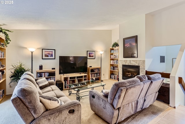 living room with a premium fireplace and light wood-type flooring