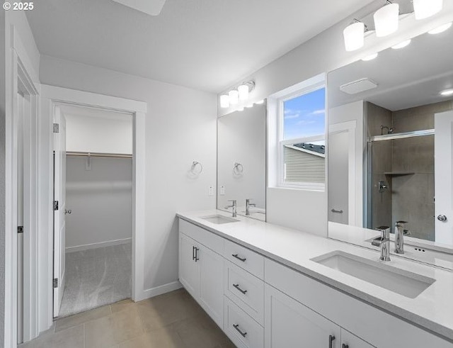 18960 SW Eureka Ln, Beaverton, OR 97007 - bathroom with double vanity, a walk in closet, a shower stall, and tile patterned floors