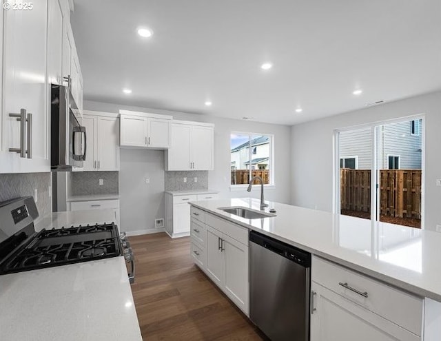18960 SW Eureka Ln, Beaverton, OR 97007 - kitchen featuring appliances with stainless steel finishes, a sink, wood finished floors, white cabinetry, and recessed lighting