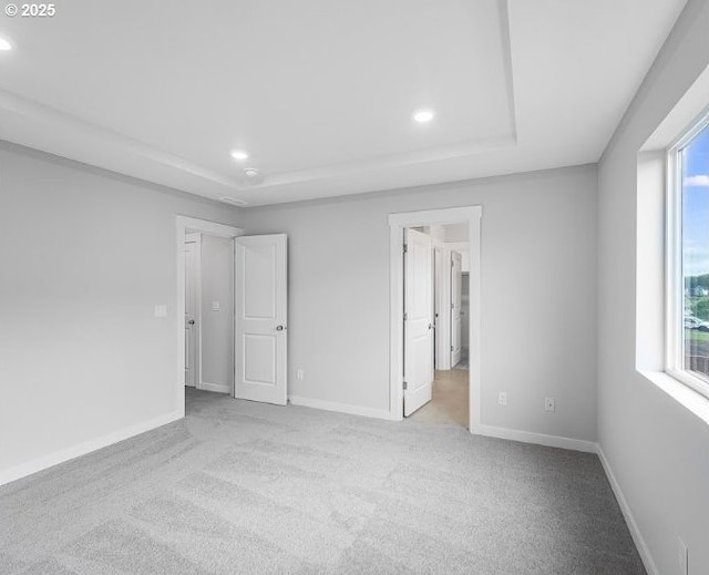 18960 SW Eureka Ln, Beaverton, OR 97007 - unfurnished bedroom featuring a raised ceiling, recessed lighting, multiple windows, and carpet flooring
