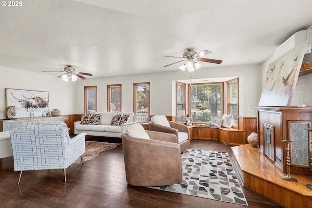 409 Pacific Ave, Brookings, OR 97415 - living area featuring a ceiling fan, a wainscoted wall, wood finished floors, and wooden walls