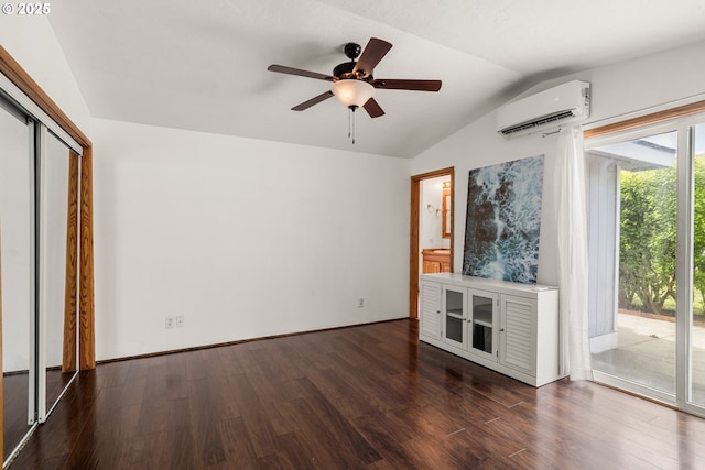 409 Pacific Ave, Brookings, OR 97415 - unfurnished living room featuring a wall mounted AC, vaulted ceiling, wood finished floors, a ceiling fan, and baseboards