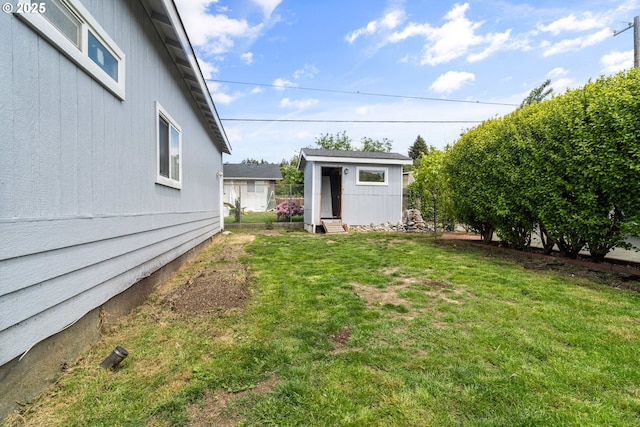 409 Pacific Ave, Brookings, OR 97415 - view of green lawn featuring entry steps and an outbuilding