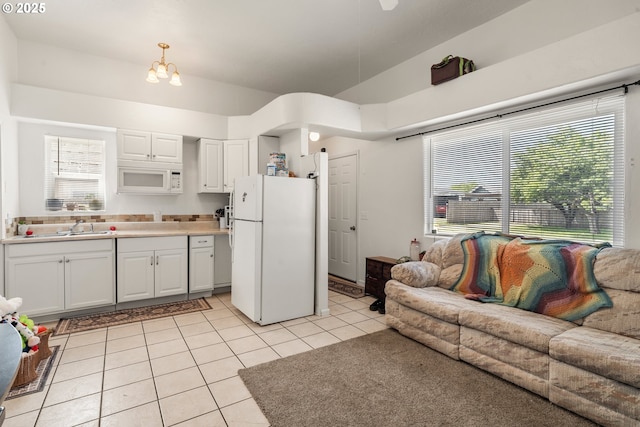 409 Pacific Ave, Brookings, OR 97415 - kitchen featuring white appliances, light tile patterned flooring, white cabinetry, a sink, and light countertops