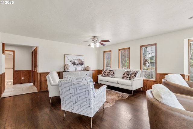 409 Pacific Ave, Brookings, OR 97415 - living area featuring wainscoting, wood walls, hardwood / wood-style floors, and ceiling fan