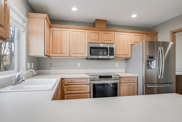 kitchen with light brown cabinetry, sink, and stainless steel appliances