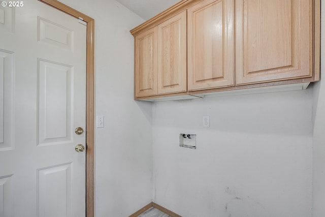 clothes washing area with cabinets and washer hookup