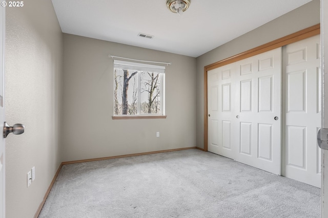 unfurnished bedroom featuring carpet floors and a closet