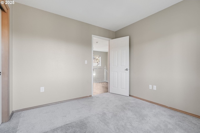 unfurnished bedroom featuring light carpet