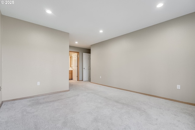 unfurnished room featuring light colored carpet