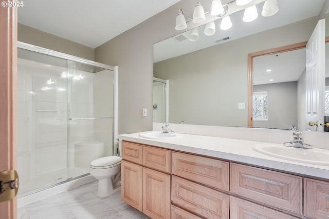 bathroom featuring vanity, toilet, and walk in shower