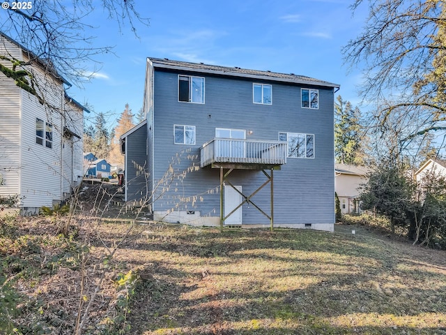 back of house with a wooden deck and a lawn