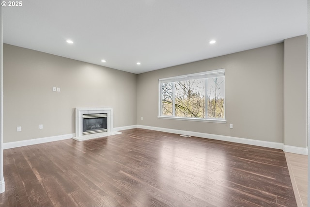 unfurnished living room featuring dark wood-type flooring