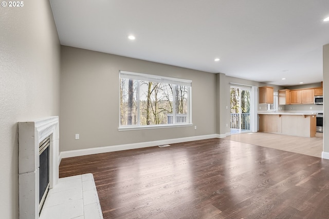 unfurnished living room with light hardwood / wood-style floors