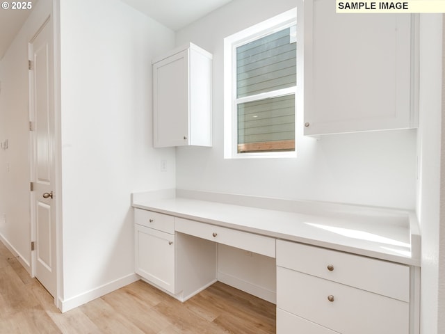 bathroom with wood finished floors, baseboards, and vanity