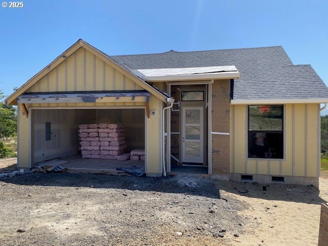 486 Meadows Dr, Manzanita, OR 97130 - view of front of house featuring board and batten siding, roof with shingles, a garage, and crawl space