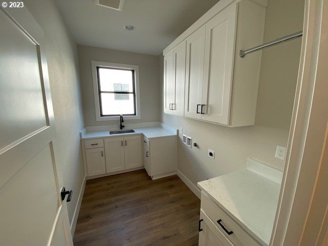 486 Meadows Dr, Manzanita, OR 97130 - laundry area featuring cabinet space, dark wood-style flooring, electric dryer hookup, hookup for a washing machine, and recessed lighting