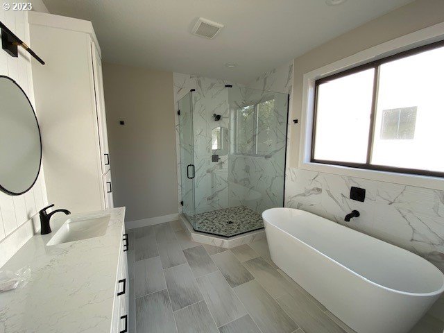 486 Meadows Dr, Manzanita, OR 97130 - full bath featuring vanity, a marble finish shower, and a freestanding tub