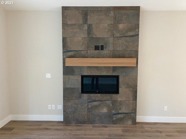 486 Meadows Dr, Manzanita, OR 97130 - detailed view of wood finished floors and a tile fireplace