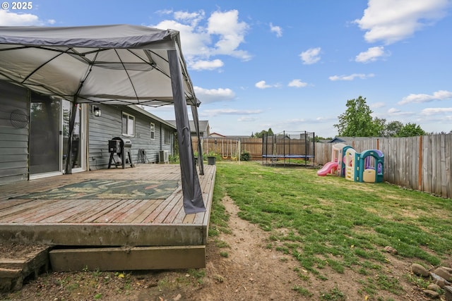 304 Frances St, Molalla, OR 97038 - fenced backyard with a trampoline and a wooden deck