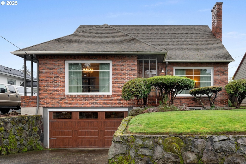 view of front of home with a garage and a front yard