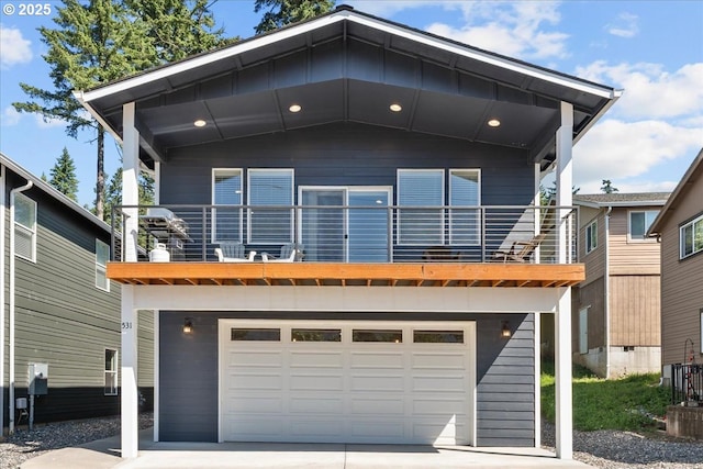 531 NW Vancouver Ave, Stevenson, WA 98648 - view of front of home with an attached garage, a balcony, and concrete driveway