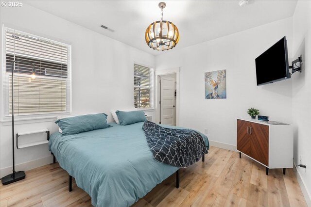 531 NW Vancouver Ave, Stevenson, WA 98648 - bedroom with a chandelier, light wood-type flooring, and baseboards