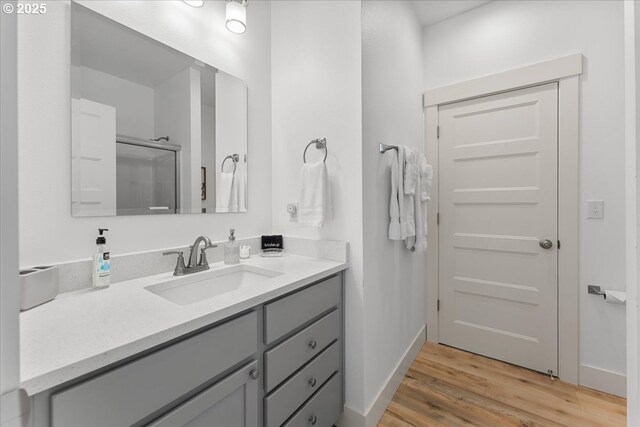531 NW Vancouver Ave, Stevenson, WA 98648 - full bath featuring vanity, wood finished floors, baseboards, and a shower with shower door