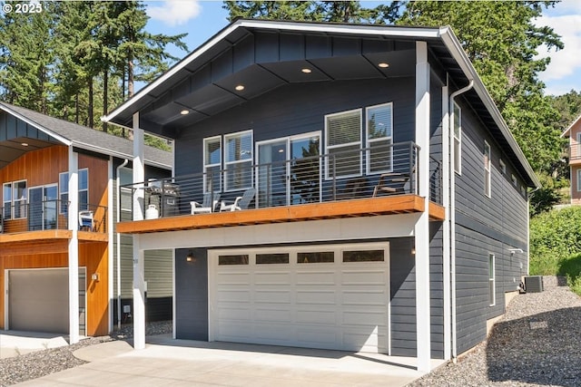 531 NW Vancouver Ave, Stevenson, WA 98648 - view of front facade with an attached garage, a balcony, central air condition unit, and driveway