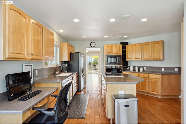 1907 Quinton St, The Dalles, OR 97058 - kitchen featuring black appliances, light wood finished floors, a kitchen island, recessed lighting, and light brown cabinets