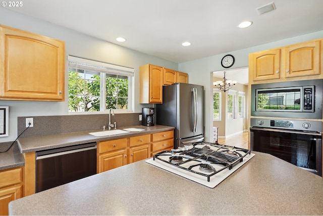 1907 Quinton St, The Dalles, OR 97058 - kitchen with stainless steel appliances, healthy amount of natural light, a chandelier, recessed lighting, and light brown cabinetry