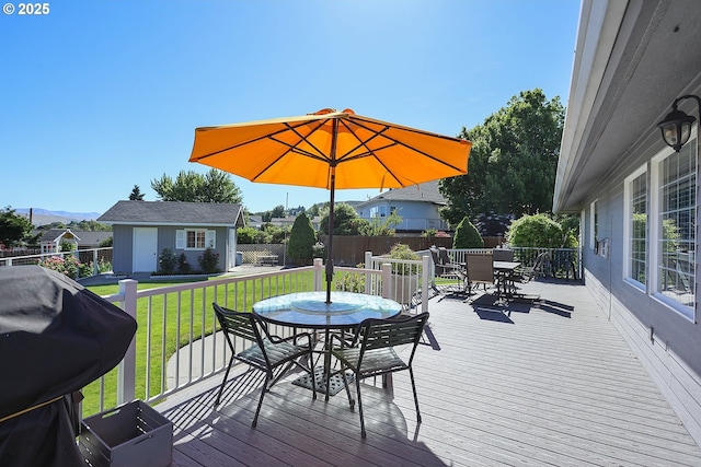 1907 Quinton St, The Dalles, OR 97058 - deck with outdoor dining space, a fenced backyard, an outdoor structure, and area for grilling