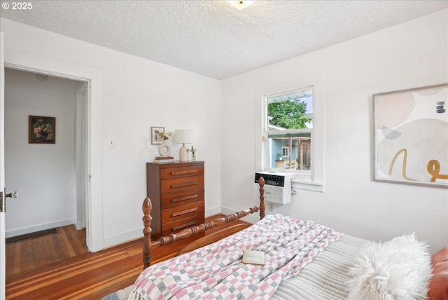 3615 NE 72nd Ave, Portland, OR 97213 - bedroom featuring wood finished floors, a textured ceiling, and a wall mounted air conditioner