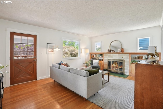 3615 NE 72nd Ave, Portland, OR 97213 - living room featuring wood finished floors, a textured ceiling, and a tile fireplace